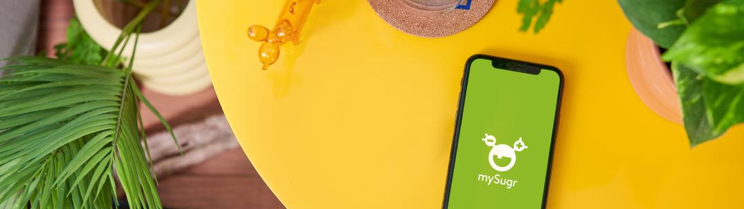 table with mobile phone and mySugr app