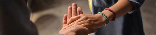 Two people holding hands
