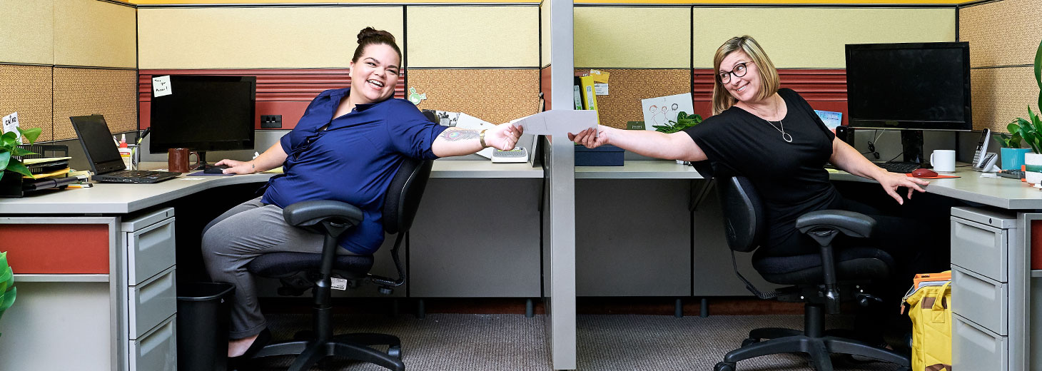 two women sitting in an office